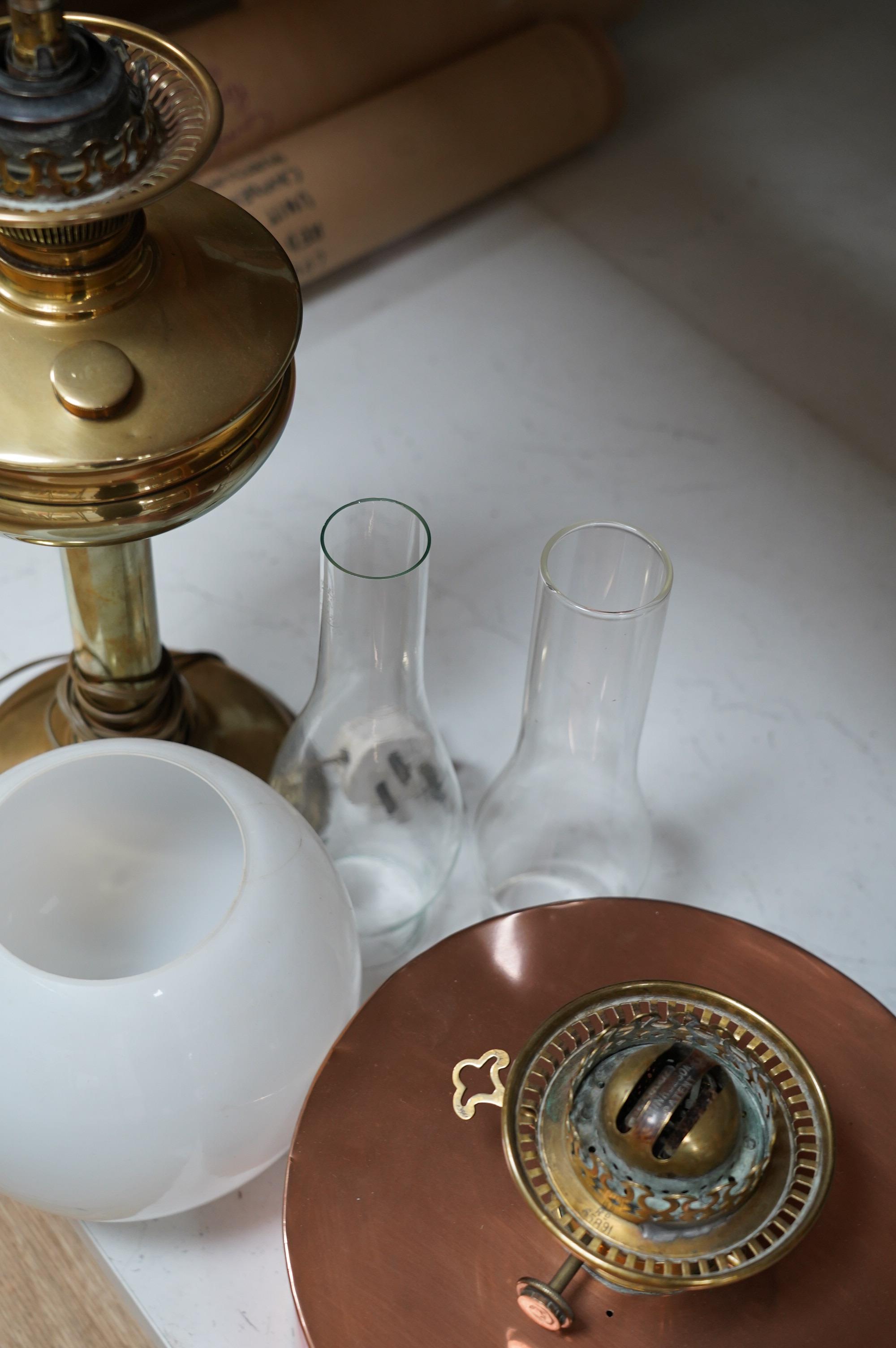 Two oil lamps to include a brass example with opaque glass shade. Condition - fair to good